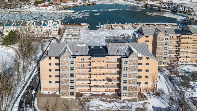 snowy aerial view with a water view