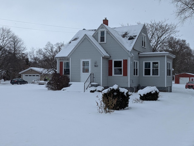 view of front of property with a garage and an outdoor structure