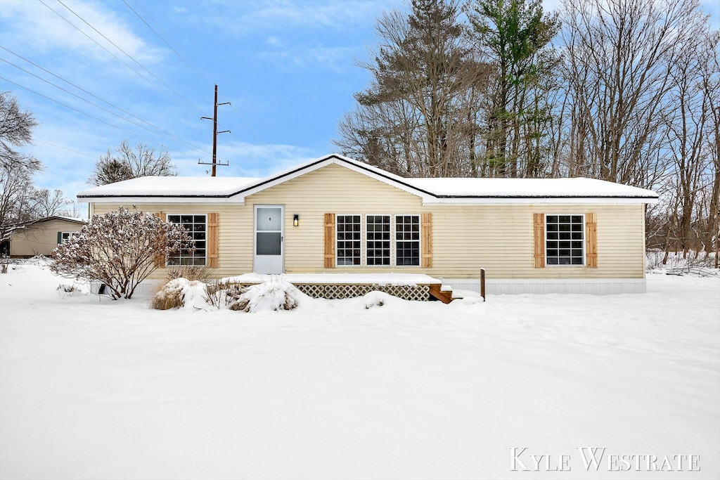 view of snow covered back of property