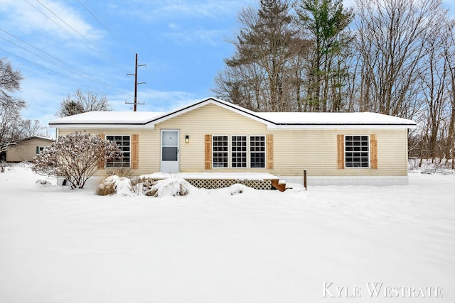 view of snow covered back of property