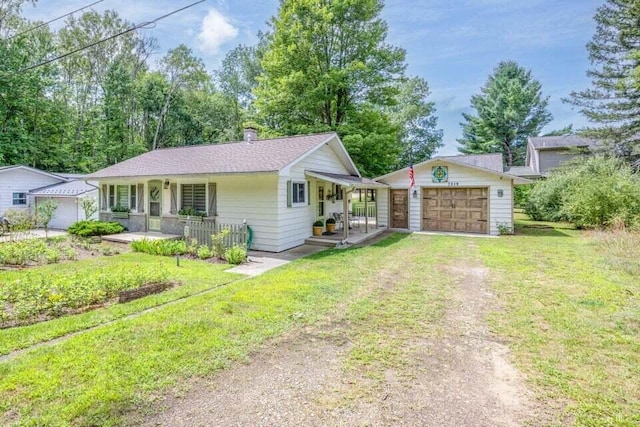 7519 9th St Unit 311, Canadian Lakes, MI 49346 - ranch-style house featuring a porch, dirt driveway, a detached garage, a front lawn, and a chimney