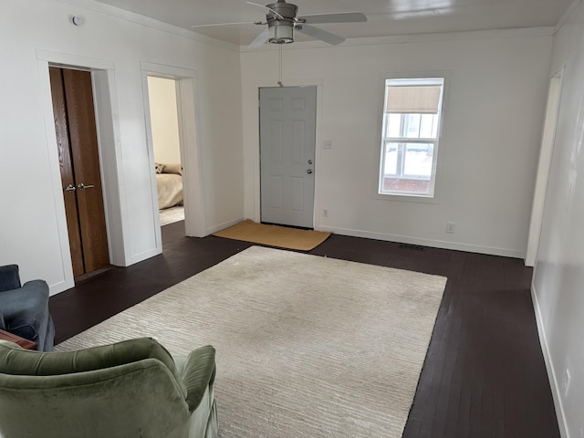 living room with ceiling fan, ornamental molding, and dark hardwood / wood-style flooring