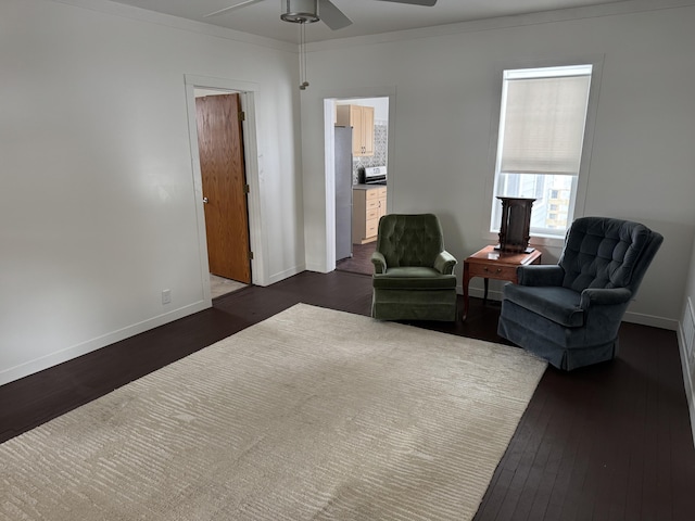 living area featuring ceiling fan, ornamental molding, and dark hardwood / wood-style floors