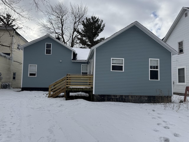 snow covered property featuring a deck