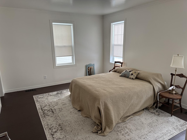 bedroom with crown molding and dark wood-type flooring