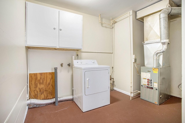 laundry room featuring washer / clothes dryer, cabinets, and heating unit