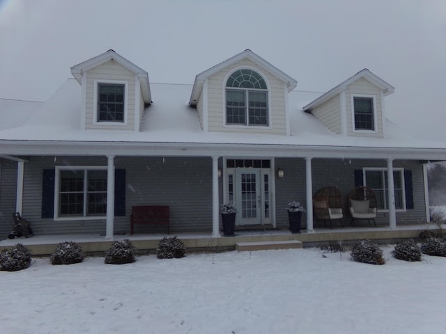 new england style home with covered porch