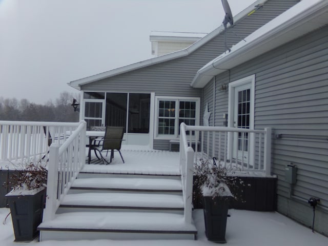 wooden deck with a sunroom