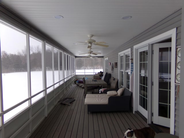 sunroom / solarium featuring ceiling fan