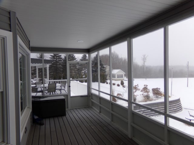 unfurnished sunroom with a healthy amount of sunlight and a water view