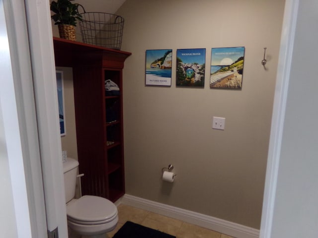 bathroom with toilet and tile patterned flooring