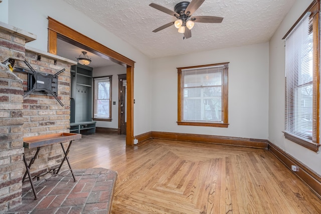 foyer with a textured ceiling and ceiling fan