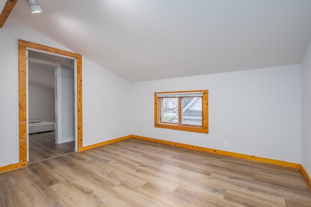 bonus room featuring light wood-type flooring and lofted ceiling