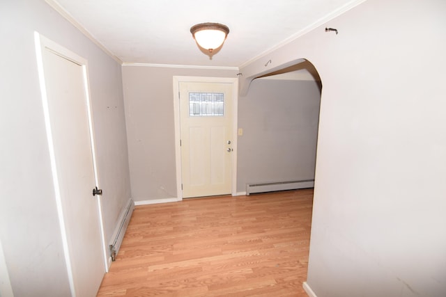 foyer entrance with light wood-type flooring, ornamental molding, and a baseboard radiator