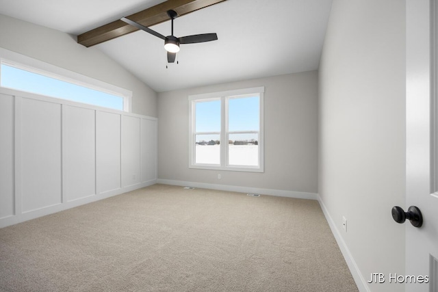 unfurnished bedroom featuring ceiling fan, light colored carpet, lofted ceiling with beams, and multiple windows