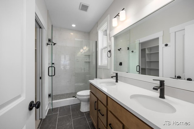 bathroom featuring walk in shower, vanity, and toilet