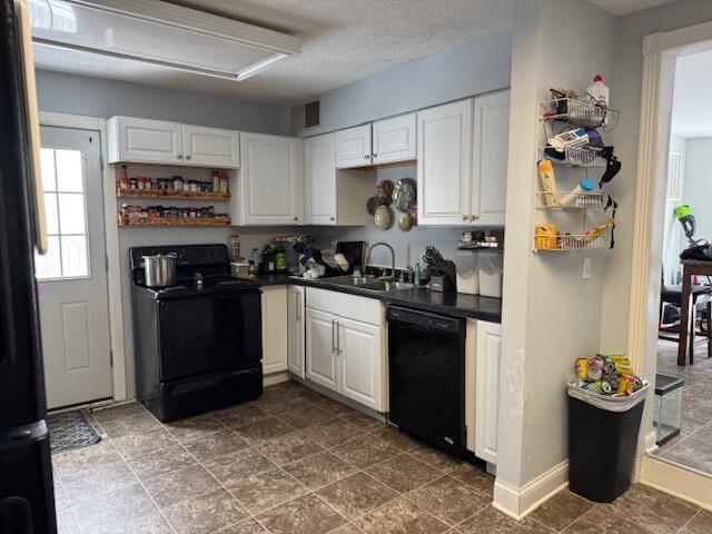 kitchen featuring sink, a textured ceiling, black appliances, and white cabinetry