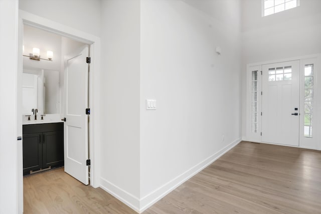 foyer featuring light hardwood / wood-style flooring and sink