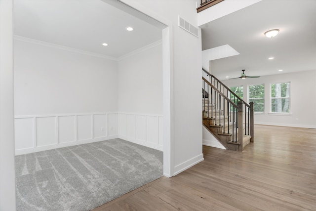 interior space with light hardwood / wood-style floors, ceiling fan, and crown molding