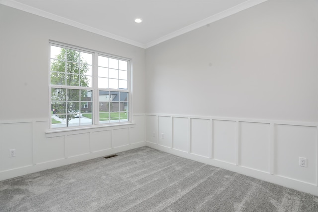 empty room with ornamental molding and light carpet