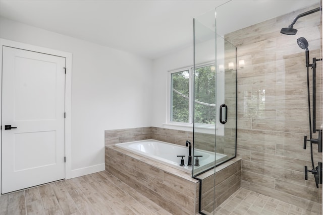 bathroom featuring hardwood / wood-style floors and plus walk in shower