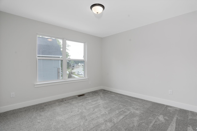 unfurnished room featuring carpet