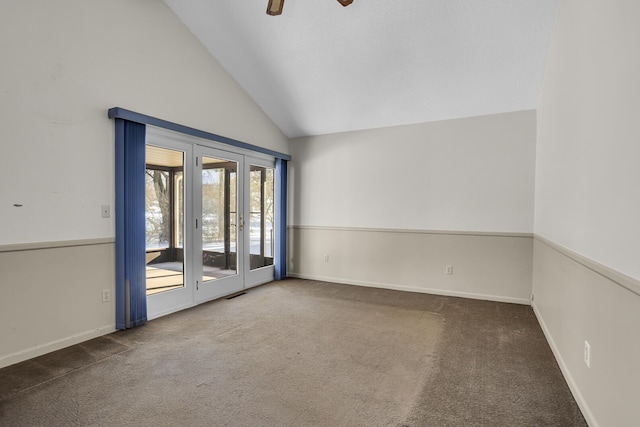 carpeted spare room featuring high vaulted ceiling and ceiling fan