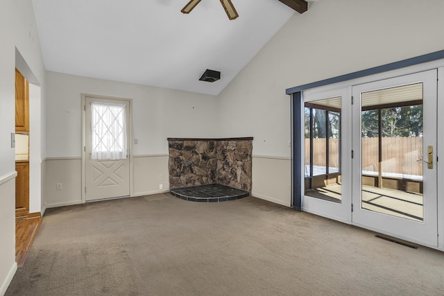 unfurnished living room with ceiling fan, light carpet, and lofted ceiling with beams