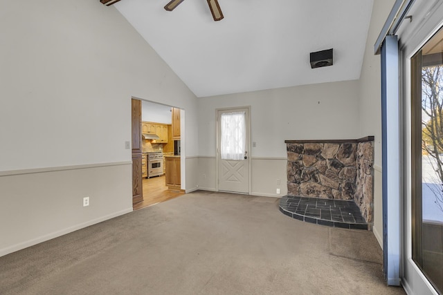 unfurnished living room featuring ceiling fan, light carpet, and lofted ceiling with beams