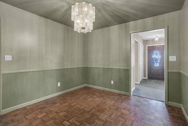 interior space featuring a chandelier and dark parquet floors