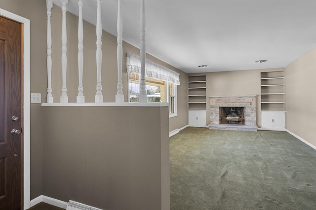 unfurnished living room featuring built in features, carpet floors, and a fireplace