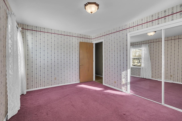 unfurnished bedroom featuring carpet floors and a closet