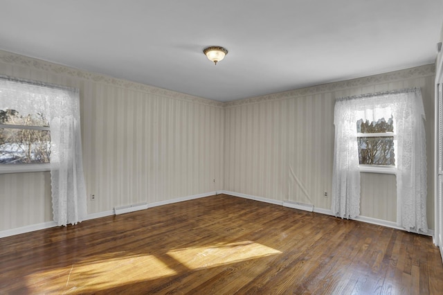 unfurnished room with dark hardwood / wood-style flooring