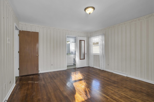 empty room with dark hardwood / wood-style flooring