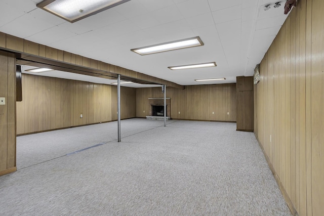 basement with wooden walls and light carpet