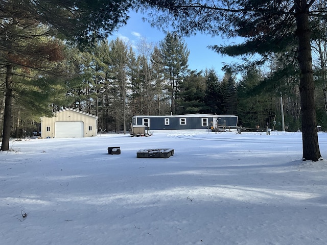 view of front facade featuring a garage and an outbuilding