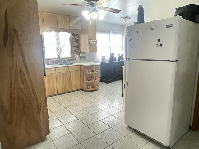 kitchen with sink, ceiling fan, white fridge, and light tile patterned floors