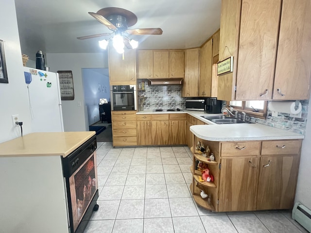 kitchen with kitchen peninsula, black appliances, a baseboard heating unit, backsplash, and sink