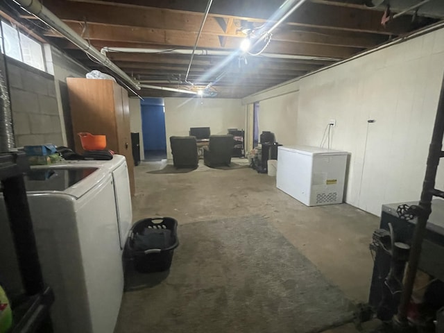 basement with washer and dryer and fridge