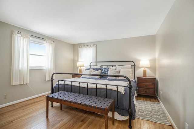 bedroom featuring hardwood / wood-style flooring and multiple windows