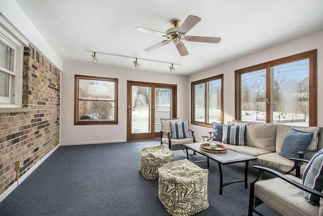 carpeted living room featuring ceiling fan