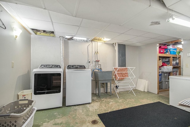 laundry room with sink, washing machine and clothes dryer, and electric panel