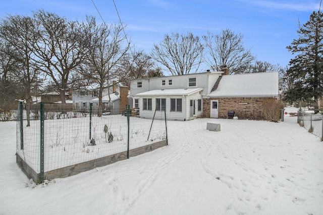 view of snow covered rear of property