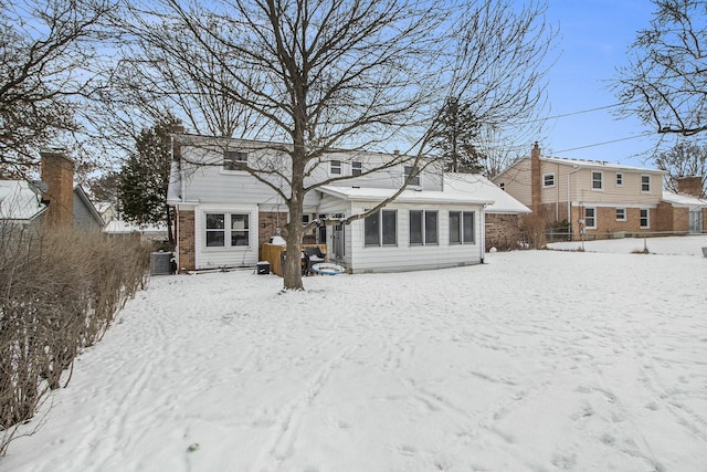 snow covered property with cooling unit