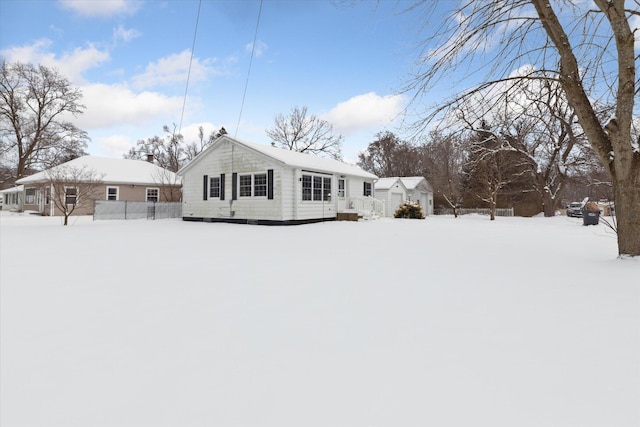 view of snow covered rear of property