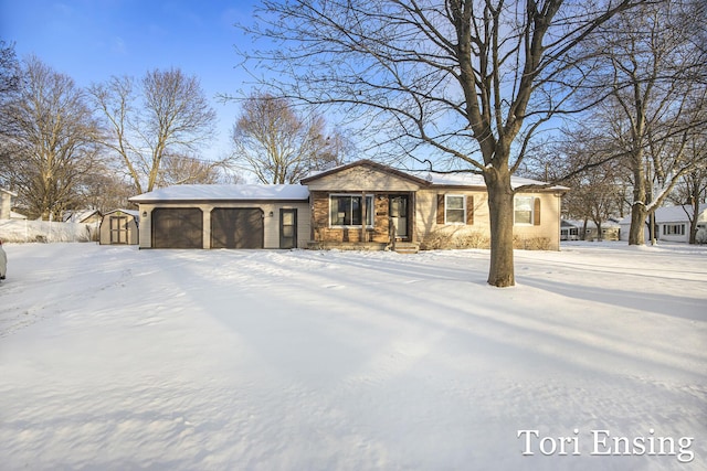 ranch-style house with a garage and a storage shed