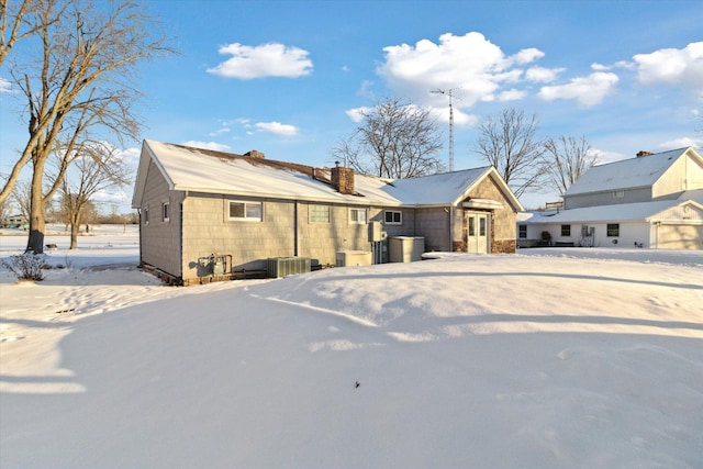 snow covered property with cooling unit