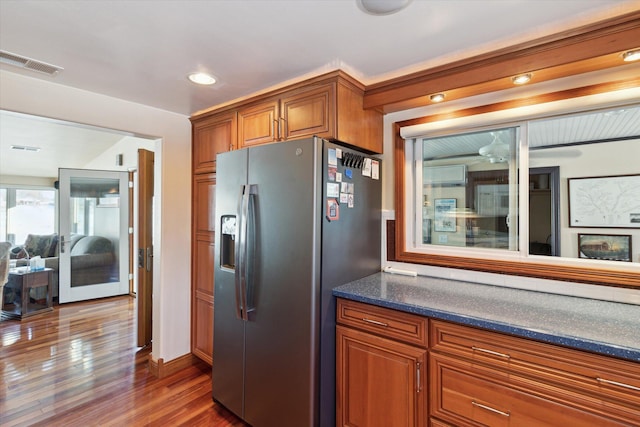 kitchen with stainless steel fridge with ice dispenser and dark hardwood / wood-style floors