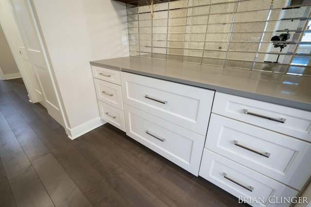 kitchen featuring stainless steel counters, white cabinets, and dark hardwood / wood-style flooring