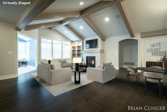 living room with dark hardwood / wood-style floors and vaulted ceiling with beams